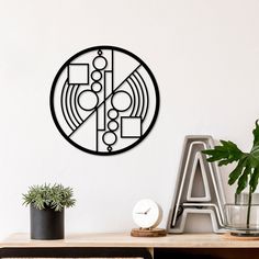 a clock is on the wall next to a potted plant and other items in front of it