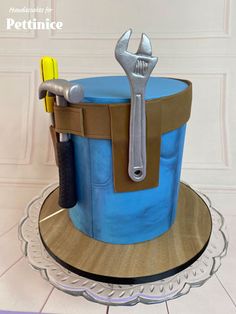 there is a cake made to look like a bucket with tools in it