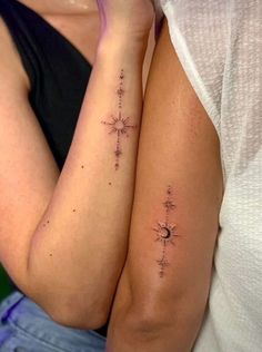 two women with matching tattoos on their arms