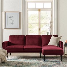 a living room with a red couch and rug