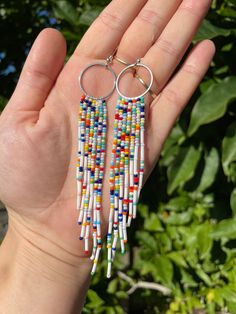 Handmade white and rainbow beaded fringe earrings. 5.5 inches long and very lightweight to wear. All earrings are designed, unique and handmade by me. All earrings are packages in an earring box packaging so can be used straight away for a gift. All orders are shipped with first class, signed for delivery with Royal Mail.  I donate £1 of every purchased item to my local Hospice. Thankyou for taking the time to visit my shop :) Please also visit my Instagram pagetheodessacraft White Dangle Tassel Earrings For Festivals, White Beaded Fringe Earrings For Festival, Bohemian White Tassel Earrings With Tiny Beads, White Bohemian Tassel Earrings With Tiny Beads, Bohemian White Tassel Earrings With Colorful Beads, White Fringe Tassel Earrings For Festivals, Rainbow Fringe Dangle Jewelry, Rainbow Dangle Tassel Jewelry, Earring Box