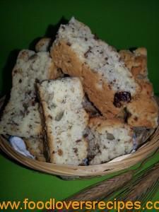 a basket full of cookies sitting on top of a green table next to a wheat stalk