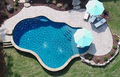 an aerial view of a swimming pool with umbrellas