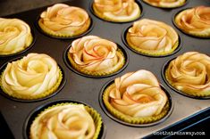 some cupcakes with yellow frosting in a muffin tin on a stove