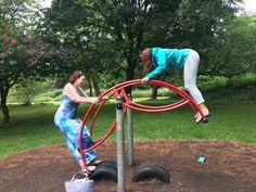 two women are playing on an outdoor playground