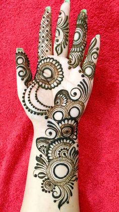 the hand is decorated with henna designs