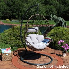 a swing chair sitting on top of a brick patio