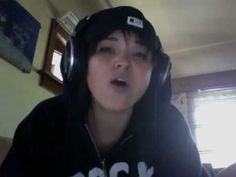 a woman wearing headphones and a black hoodie with the word rock on it