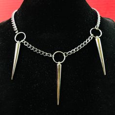 Punk Rock Triple Spikes Necklace Choker O Ring Necklace O-Ring Thorns Pendants On Silver Color Curb Chain Necklace Choker. Approximate Length 18” Width 5mm. Material: Steel Chain, Silver Or Stainless Steel Color Plated Alloy Spikes And Oring , Spikes Punk Length: 2” Spikes Are Hollow Light Weight O-Ring Diameter: 15mm Please Be Aware That The Items Have Spikes. Please Be Cautious And Be Careful In Using Them. By Purchasing The Items, You Are Aware And Take Your Own Risk Of Anything Involved In U Black Rock Jewelry, Punk Chain Jewelry For Alternative Fashion, Punk Style Chain Jewelry For Alternative Fashion, Punk Style Stainless Steel Jewelry For Party, Punk Stainless Steel Jewelry For Party, Rock Style Jewelry Choker For Alternative Fashion, Rock Style Choker Jewelry For Alternative Fashion, Punk Style Stainless Steel Party Jewelry, Rock Style Choker For Alternative Fashion