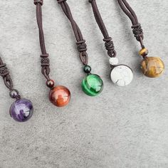 Discover the beauty, symbolism, and versatility of the Stone Sphere Rope Necklace as it becomes a unique expression of your style and connection to the energy of natural gemstones. Spheres are symbolic of completeness, unity, and the cyclical nature of life. The stone sphere on this necklace serves as a reminder of the interconnectedness of all things and the continuous flow of energy. The rope necklace is suitable for both everyday wear and special occasions. Its adjustable design and natural e Agate Round Pendant Necklace For Healing, Agate Round Pendant Crystal Necklace For Healing, Spiritual Agate Round Pendant Crystal Necklace, Agate Crystal Necklace With Round Pendant For Healing, Spiritual Agate Crystal Necklace With Round Pendant, Obsidian Amulet Necklace As Gift, Obsidian Amulet Necklace For Gift, Spiritual Round Agate Crystal Necklace, Obsidian Gemstone Beads Necklace As Gift