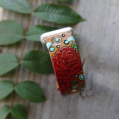 "Red Rose and Turquoise Apple Watch Band This is a personalized, made to order listing; please allow time for its creation. Just click the Shipping & Policies tab to view our current production turnaround time. Pick your color scheme (where applicable) and your new watch band will be made just for you! Stained in a saddle tan with hand painted red roses and turquoise accents. If your design requires a hand-stamped name or quote (which we love to add!) please leave that information in the not Custom Handmade Apple Watch Band As Gift, Handmade Red Watch Bands For Gift, Handmade Red Watch Bands As Gift, Leather Apple Watch Band, Turquoise Accents, New Watch, Apple Watch Bands Leather, Leather Work, Apple Watch Band