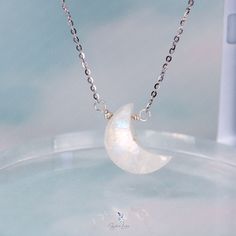 This elegant crescent moon pendant necklace features a crescent moon shape moonstone with blue flash, on solid 925 sterling silver cable chain and platinum plating. Add this elegant crescent moon moonstone pendant necklace to your everyday fine jewelry collection or as gift for your loved ones. Pendant dimensions: 0.68 x 0.48 inNecklace length: 17.5 in with the adjustable ballMaterials: moonstone, 925 sterling silver Jewelry Care: See more information about how to care for your jewelry here. Shipping Policy: Orders will be shipped within 1-3 business days. Economy shipping will take 7-14 days to arrive and standard shipping is 1- 4 days for U.S. orders. International shipping time is depended on the country and per shipping method. Shipping cost will be calculated at check out.For more det Elegant Crescent Moonstone Jewelry, White Gold Moon-shaped Moonstone Jewelry, Silver Moonstone Moon Necklaces, Moon-shaped Sterling Silver Crystal Necklace, Silver Sterling Silver Moon Crystal Necklace, Silver Moon-shaped Sterling Silver Crystal Necklace, White Sterling Silver Necklace With Moon Charm, Celestial Sterling Silver Crystal Necklace With Moon Charm, White Moonstone Crystal Necklace With Moon Charm