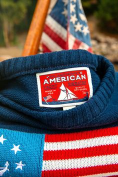 A tradition sewn long ago on the seas of coastal America, the Yacht Flag was a literal right of passage in US waters. These days, this 13-star Betsy Ross flag with a fouled anchor in the union is the ultimate symbol of liberty and leisure. Proudly made in the USA,  you can take the helm of your next adventure with the Lobster Sweater, American Sweater, Preppy Men, Preppy Mens Fashion, Ivy Style, The American Dream, New England Style, Navy Blue Background, Woven Labels