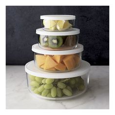 three tiered glass food storage containers filled with fruits and veggies