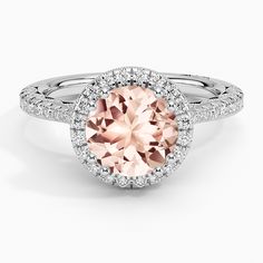 a ring with an oval pink diamond surrounded by diamonds