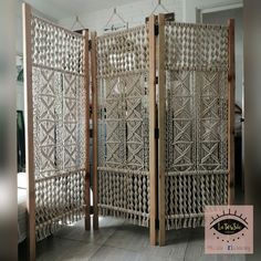 two wooden dividers made out of wicker in a room with tile flooring