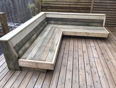 a wooden bench sitting on top of a wooden deck