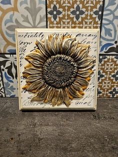 a sunflower is shown on the side of a wall with tiles in the background