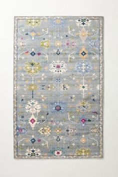 a blue rug with various colored flowers on it