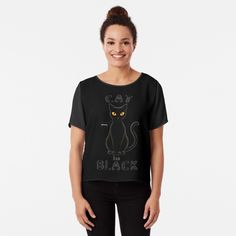 a woman wearing a black cat t - shirt