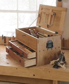 an open wooden box sitting on top of a table