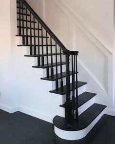 a black and white staircase in an empty room