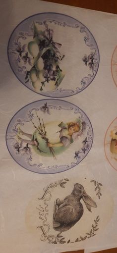 three plates with designs on them sitting on a table