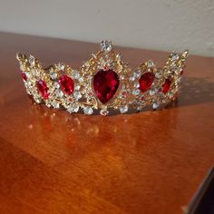 a tiara on a table with red and white stones