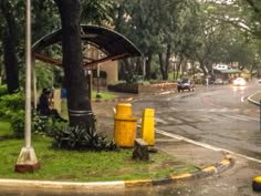 a person sitting on a bench in the rain