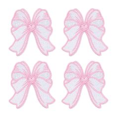 four pink bows with white glitters on the side and one in the middle, all tied