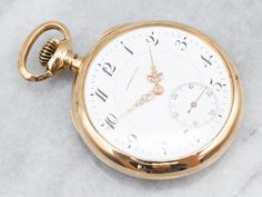 "This sleek, open-face pocket watch was engraved in 1907. On the back of the fine 18K yellow gold case, \"CES\" is engraved beautifully in French script. Like all of the antique pocket watches we sell, this piece is in beautiful working order. Please note that this piece has its original monogram, and unfortunately, this piece cannot be altered without affecting the quality of the piece. Please feel free to contact us to help you find the perfect piece for your style and budget! Case Material: 18K Yellow Gold Measures: 45 x 62 mm Monogram: \"CES\" in French Script To view a video of this piece check out the link below: https://vimeo.com/821428984 SKU #: A26007 Each piece has been identified and graded by a Graduate Gemologist who has been certified by the Gemological Institute of America ( Gold Pocket Watch, French Script, Antique Watch, Pocket Watch Antique, Vintage Pocket Watch, Cuff Watch, Pocket Watch Chain, Vintage Diamond Rings, Antique Watches