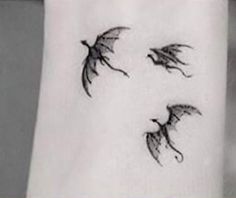 three small birds flying in the air on a woman's left wrist tattoo design