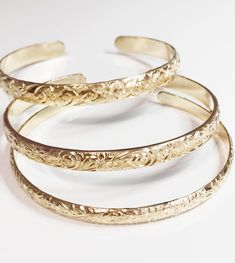 This listing is for 1 cuff bangle only. Hawaiian heirloom cuff bangle is make with 14k gold filled decorative floral pattern wire. Bangle is hand- formed, hammered and polished for a stunning texture and shine. It looks great worn alone or paired with other shell and charm bangles to create a chic, fun beachy look. Cuff bangle is about 4, 5 & 6mm wide and 1.5mm thick. PLEASE NOTE: ALL MY BANGLES, RINGS AND 14K SOLID GOLD JEWELRY ARE CUSTOM MADE TO ORDER SO THEY CAN'T BE EXCHANGE OR RETURN FO Adjustable Heirloom Gold Bangle Bracelet, Classic Adjustable Cuff Bracelet With Intricate Design, Classic Round Cuff Bracelet For Ceremonial Occasions, Classic Adjustable Etched Bangle, Classic Round Ceremonial Cuff Bracelet, Engraved Cuff Bangle For Wedding, Elegant Etched Cuff Bracelet For Anniversary, Classic Ceremonial Cuff Bangle Bracelet, Classic Ceremonial Cuff Bracelet Styled As Bangle