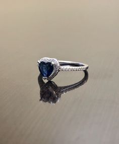 DeKara Designs Clearance A Beautiful Unique 14K White Gold Heart Shape Blue Sapphire Halo Diamond Engagement Ring. Metal- 14K White Gold, .583 Modern, Three Prong Set, Pave Set, White Gold Ring. Stones- 1 Genuine Heart Shaped Natural Blue Sapphire 0.85 Carats. 38 Round Diamonds, H Color VS2-SI1 Clarity, 0.13 Carats. Beautiful and Timeless Halo Diamond Halo Heart Shape Blue Sapphire Engagement Ring Made in 14K White Gold. The ring features a beautifully cut heart shape blue sapphire that is profe Heart Shaped Sapphire Rings For Formal Occasions, Blue 14k White Gold Wedding Ring, Blue Rings For Valentine's Day Formal Occasion, Sapphire Promise Ring With Brilliant Heart Cut, Blue Sapphire Wedding Ring In 14k White Gold, White Gold Sapphire Ring For Wedding, Tanzanite Halo Jewelry For Wedding, White Gold Sapphire Ring With Trillion Cut For Wedding, White Gold Sapphire Ring For Wedding With Trillion Cut