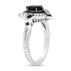 a white gold ring with an oval black diamond surrounded by two smaller diamonds on the side