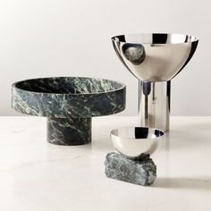 marble bowls are sitting on top of each other, with one bowl in the middle