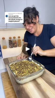 a woman cutting up food on top of a wooden table