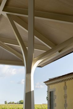 an outdoor covered patio with table and chairs