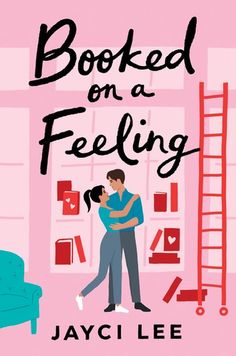 a man and woman hug in front of a pink wall with bookshelves on it