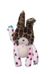 a stuffed animal that is wearing polka dots and holding it's paws up in the air