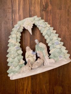 a nativity scene is displayed on a wooden wall in front of the door to a home