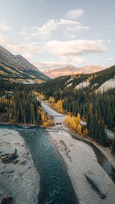 an aerial view of a river surrounded by mountains