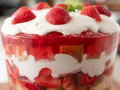 a layered dessert with strawberries and whipped cream