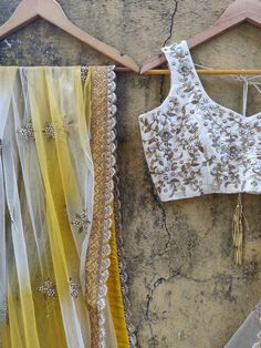 This ivory raw silk lehenga with paisley embroidery is paired with an ivory embroidered raw silk blouse.  The outfit is complemented with a net yellow and ivory shaded dupatta with a scalloped border. Western Sari, Shaded Dupatta, Ruffle Lehenga, Ivory Lehenga, Raw Silk Blouse, Indian Wedding Lehenga, Paisley Embroidery, Raw Silk Lehenga, Yellow Lehenga