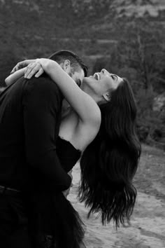 black and white photograph of a couple kissing