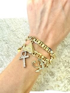 - 18K Gold plated Egyptian charm bracelet - Choose between the two styles - 8mm thick mariner link chain, size is 8", non adjustable Ancient Egypt Jewelry, Egyptian Bracelet, Egypt Jewelry, Egyptian Symbols, Egyptian Jewelry, Charms Bracelet, Eye Of Horus, Ancient Egypt, Link Chain