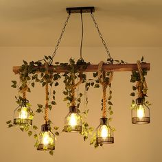 a bunch of lights that are hanging from a wooden beam with ivy growing on them