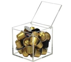 a clear box filled with lots of gold cups