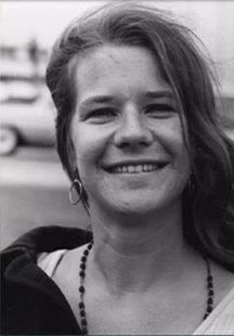 a black and white photo of a woman smiling