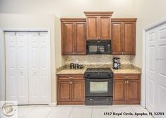 a kitchen with wooden cabinets and granite counter tops